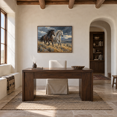Windbreak oil painting of a dark and a pale horse running through windswept grass displayed in a ranch study