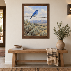 Mountain Bluebird Western oil painting framed on a light entryway wall above an oak bench