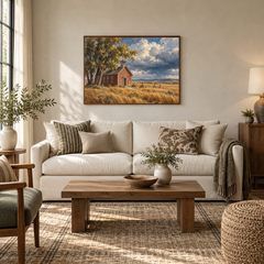 Prairie Schoolhouse Western oil painting displayed in a sunlit living room above a cream sofa