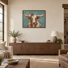 Longhorn With Wildflower Crown oil painting displayed above a living room sideboard