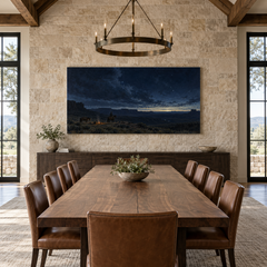 Last Watch Before Dawn above a long table in a limestone and leather dining room