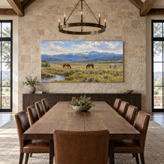 The Quiet Horses above a long table in a limestone and leather dining room