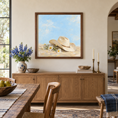 Cowgirl Hat & Wild Daisies oil painting displayed above a dining room sideboard