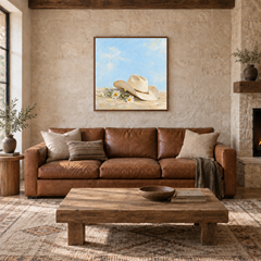 Cowgirl Hat & Wild Daisies oil painting displayed in a ranch living room