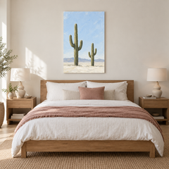 Two Saguaros Under Pale Sky oil painting displayed in a Warm Minimalist bedroom