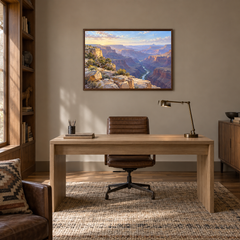 First Light Over the Canyon oil painting displayed in a natural-wood study