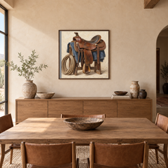 Saddle & Rope painting framed in a adobe-inspired dining room