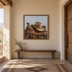 Cowboy Hat on Saddle painting framed in a Southwestern entry hall